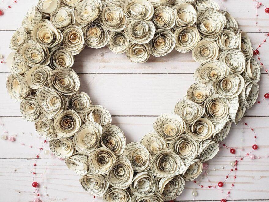 Image is of a heart shaped wreath created with paper roses. The paper appears to be from old books.